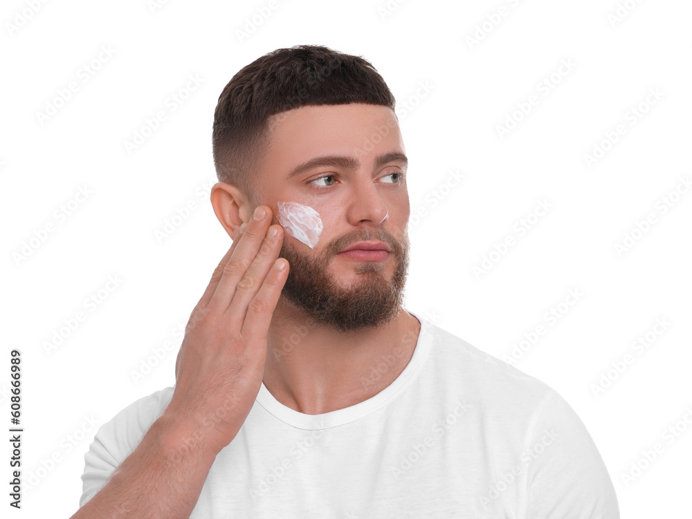 Handsome man applying cream onto his face on white background Handsome man applying cream onto his face on white background