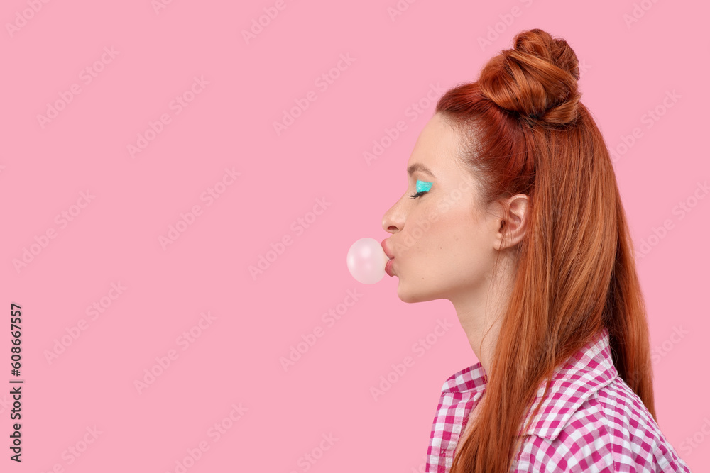 Beautiful woman with bright makeup blowing bubble gum on pink background. Space for text