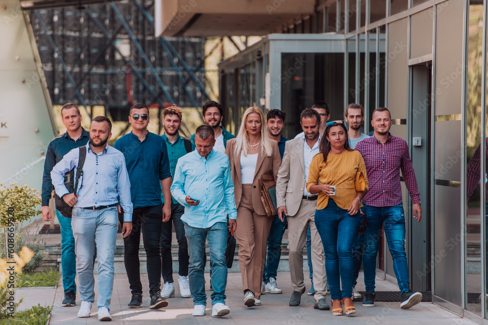 A diverse group of businessmen and colleagues walking together by their workplace, showcasing collaboration and teamwork in the company. A diverse group of businessmen and colleagues walking together by their workplace, showcasing collaboration and teamwork in the company.