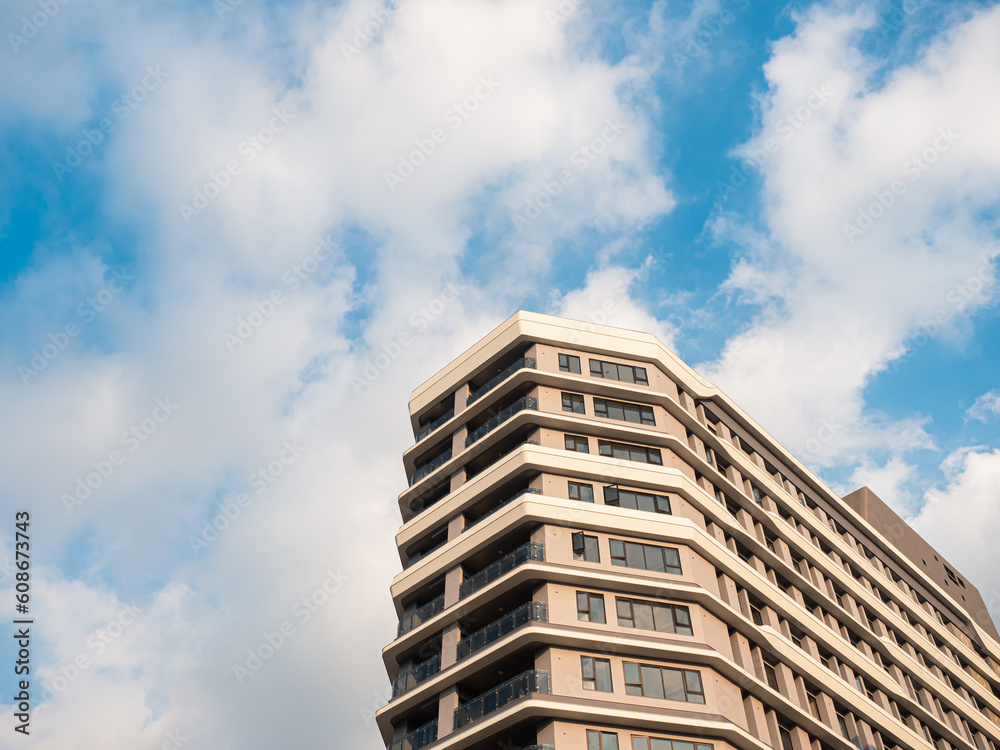 a white building with cloud and blue sky a white building with cloud and blue sky