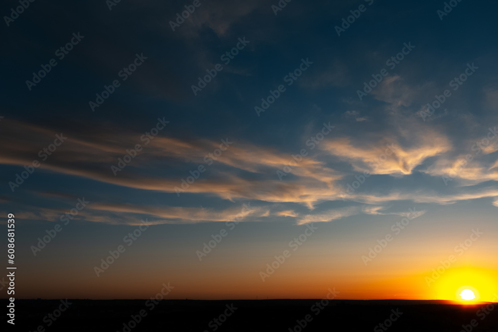 Natural landscape of beautiful colourful sunrise with yellow clouds.