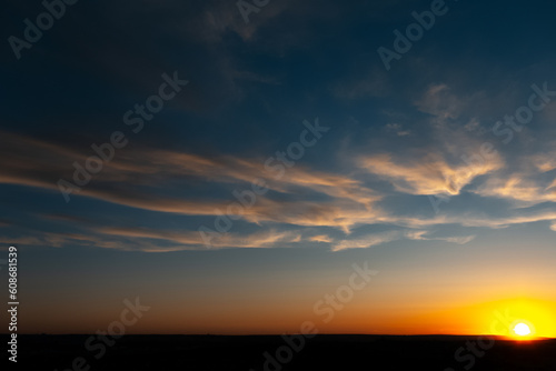 Natural landscape of beautiful colourful sunrise with yellow clouds.