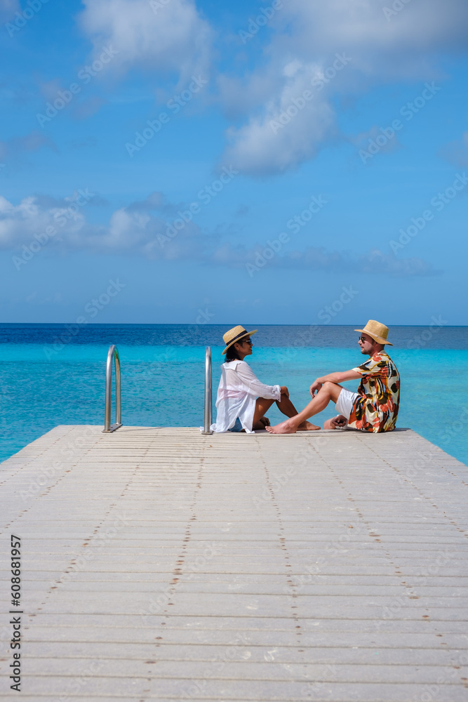 Playa Porto Marie Beach in Curacao, a Couple of men and woman on a tropical beach on the Caribbean Island of Curacao. 