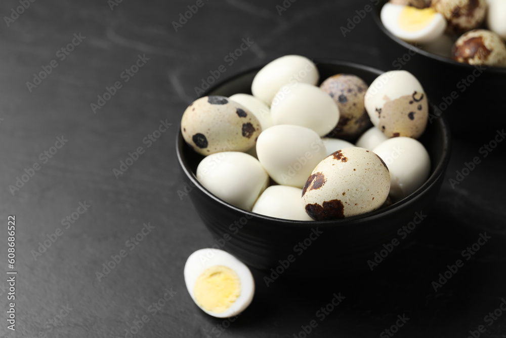 Unpeeled and peeled hard boiled quail eggs on black table, space for text Unpeeled and peeled hard boiled quail eggs on black table, space for text