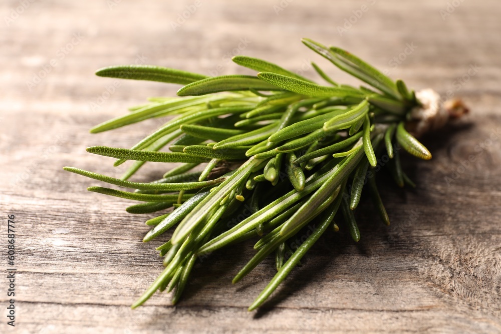Fresh green rosemary on wooden table, closeup Fresh green rosemary on wooden table, closeup