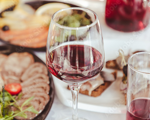 Close up of glasses of wine and snacks on the table
