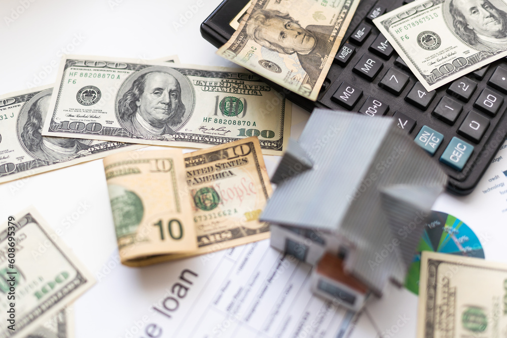 Small toy house is lies on money, bank form. Small toy house is lies on money, bank form.