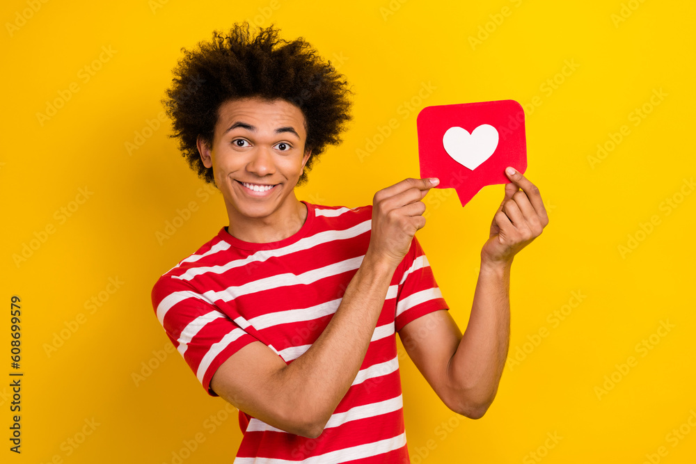 Portrait of cheerful nice person toothy smile hands hold paper like notification card isolated on yellow color background Portrait of cheerful nice person toothy smile hands hold paper like notification card isolated on yellow color background