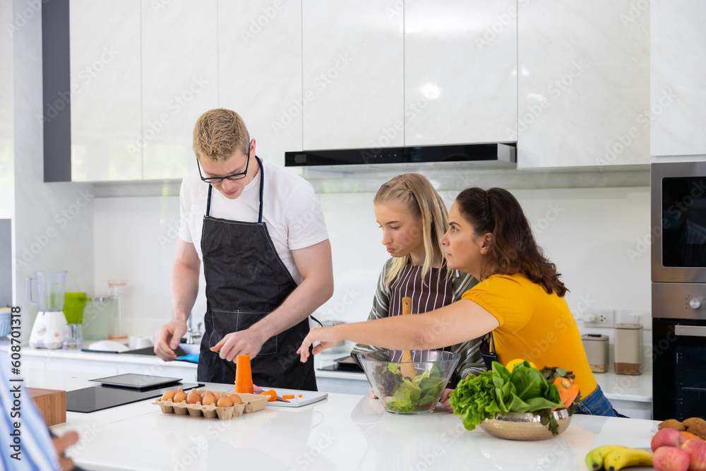 Happy family cooking together on kitchen. happy smiling parents enjoy weekend Happy family cooking together on kitchen. happy smiling parents enjoy weekend