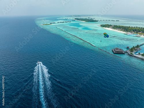Aerial View, Maldives, North Malé Atoll, Indian Ocean, Lankanfushi, Paradise Island, Paraglider with Boat photo