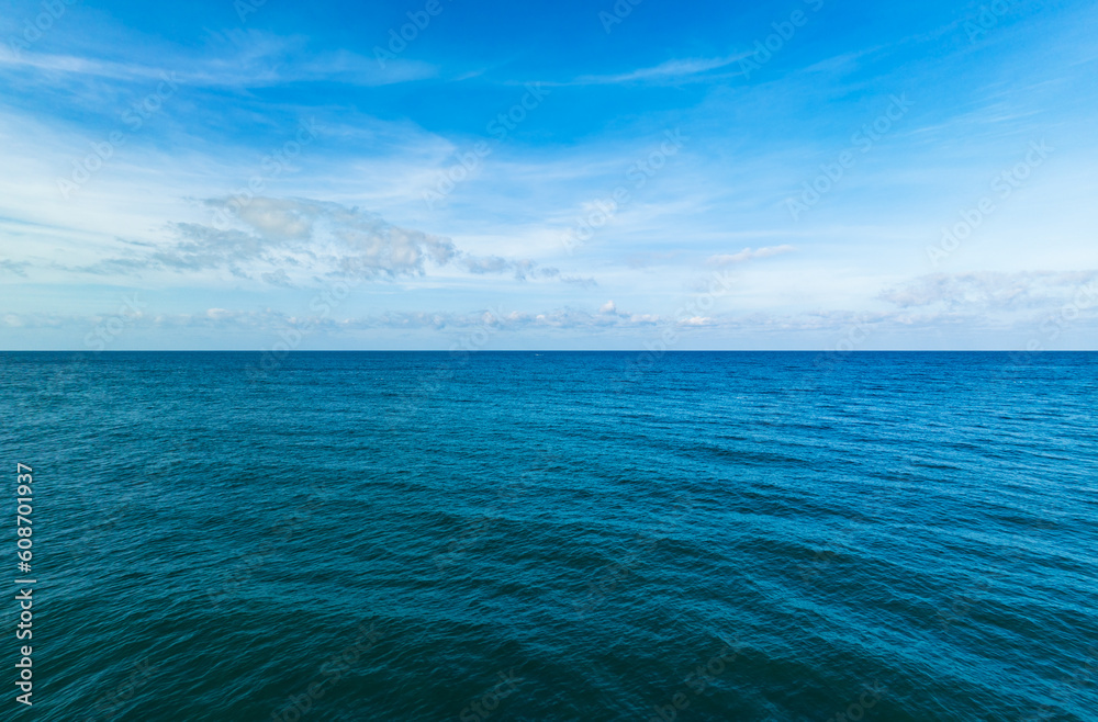 Obraz premium Aerial view of a blue sea surface water texture background,Amazing sun reflections Aerial flying drone view, Waves water surface texture on sunny tropical ocean, Infinity sea nature seascape
