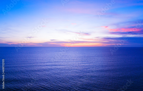 Aerial view sunset sky, Nature beautiful Light Sunset or sunrise over sea, Colorful dramatic majestic scenery Sky with Amazing clouds and waves in sunset sky blue light cloud background © panya99