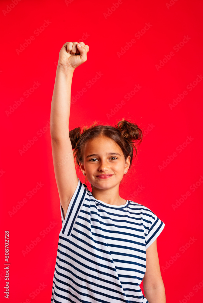 Cheerful girl with raised arms in studio Cheerful girl with raised arms in studio