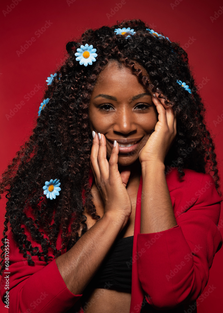 Smiling young romantic woman with flowers on curly hair Smiling young romantic woman with flowers on curly hair