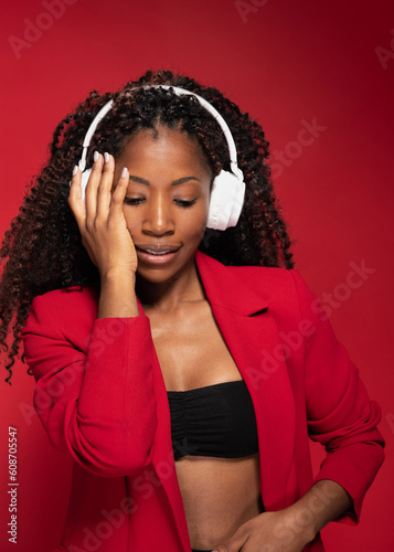 Pensive woman with hands on headphones photo