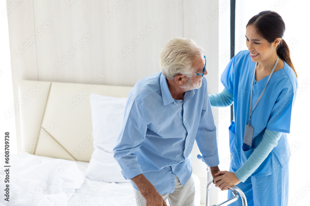 Fototapeta premium Female Nurse assisting senior patient at nursing home. Home care. disabled old man with walker at home. Professional caregiver nursing home