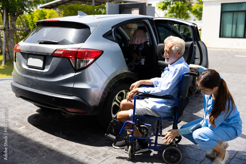Female Caregiver helping disabled senior man get into the car. Professional caregiver nursing home. Nurse assisting senior patient at nursing home