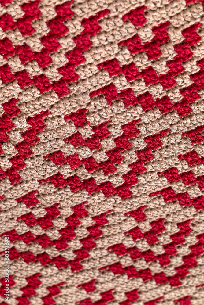 Abstract crochet pattern. Red beige ctochet mosaic pattern. Knitted background. Abstract crochet pattern. Red beige ctochet mosaic pattern. Knitted background.