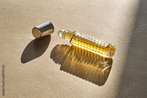 Fototapeta Naklejka Na Ścianę i Meble -  Oil roller perfume on a beige background.