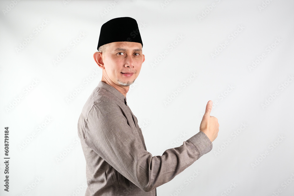 Portrait of Asian Moslem Man doing positive gesture with hand, thumbs up, ok sign
Portrait of Asian Moslem Man doing positive gesture with hand, thumbs up, ok sign