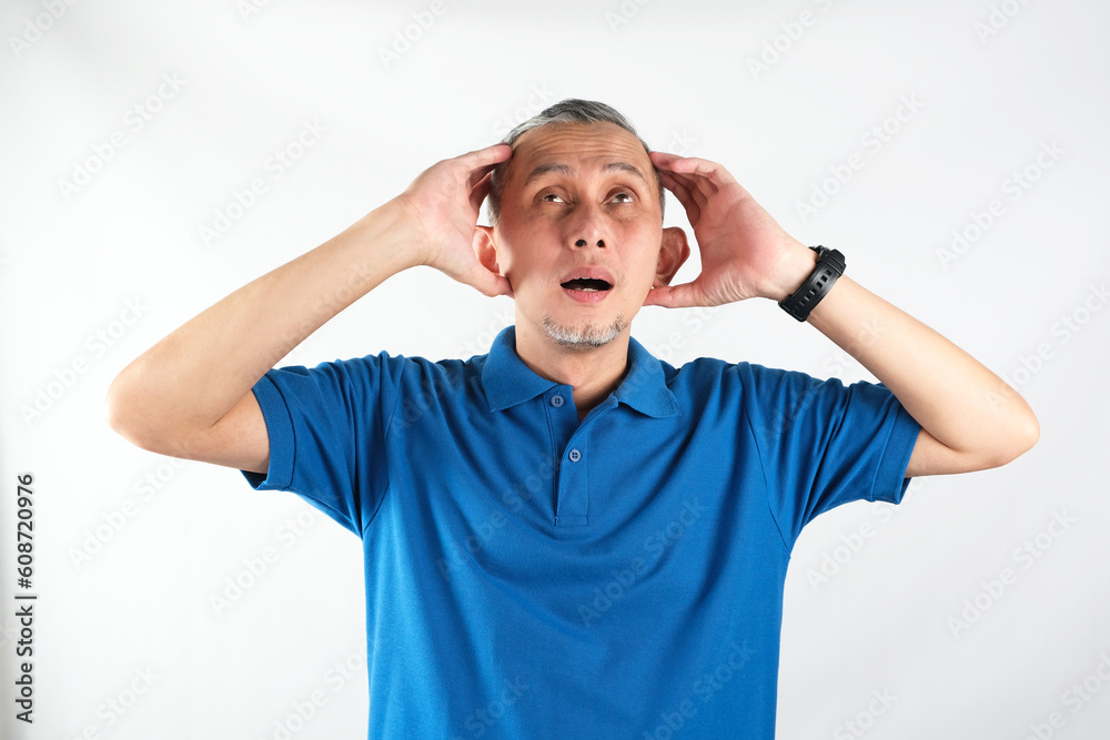 Portrait of Adult Asian Man showing stress expression. Suffering migraine.
Portrait of Adult Asian Man showing stress expression. Suffering migraine.
