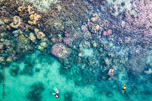 Fototapeta Naklejka Na Ścianę i Meble -  Tourist snorkeling with coral reef in tropical sea on vacation