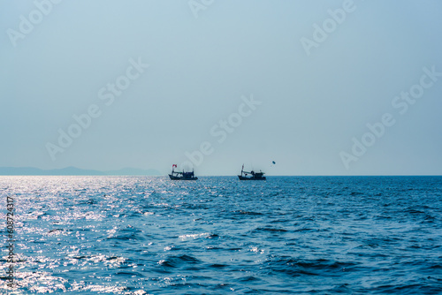 Fishing boat floating on blue sea