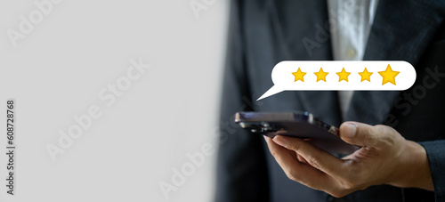 Human use phone showing give feedback icon satisfaction survey, five star, customer, satisfaction, review, feedback, top service excellent, Quality assurance 5 star, positive, customer service