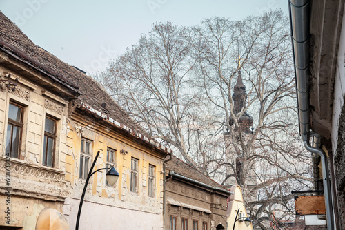 Panorama of the city of Sremski Karlovci, in Vojvodina, Serbia, with a typical vintage street with austro hungarian buildings and Lower Church,, or Donja Crkva Svetih Apostola petra i Pavla in backgro photo
