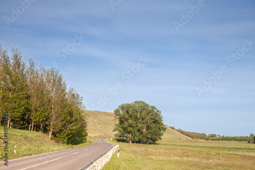 Panorama of a rural countryside road in Serbia, asphalted, with fields and titelski breg in background. Titelski breg, or titel breg, is a major natural landmark of Serbia and Vojvodina.