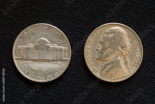 Old nickel coin of 1961, portrait of third president of the United States Thomas Jefferson on obverse and Monticello, Jefferson's home on reverse. Isolated on grey cloth background photo