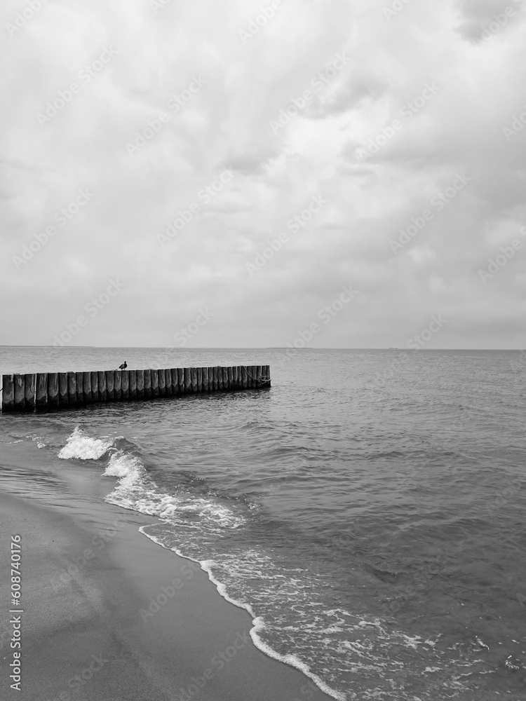 Gray cloudy seascape, cloudy weather at the sea, empty beach
