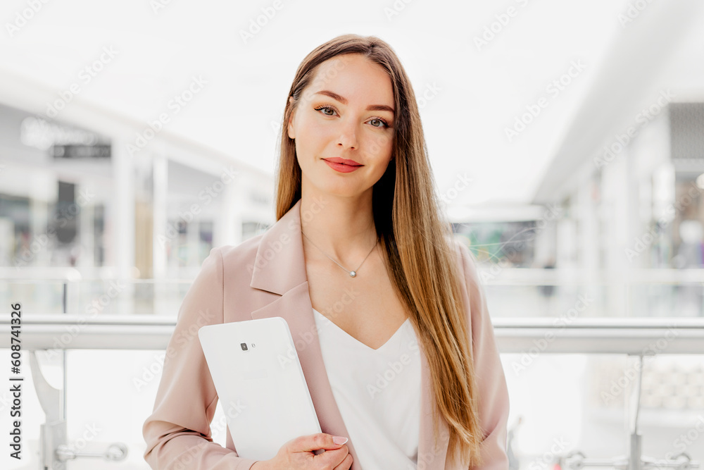 business woman holding digital tablet standing in the business center business woman holding digital tablet standing in the business center