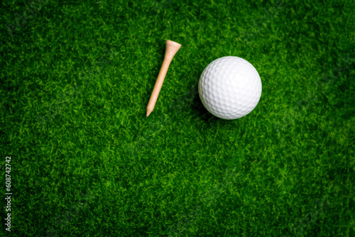 Golf ball close up on tee grass on blurred beautiful landscape of golf background. Concept international sport that rely on precision skills for health relaxation..
