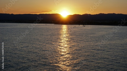 sunset over mountains and water