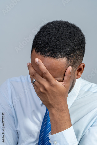 Portrait of a man with hand covering his face