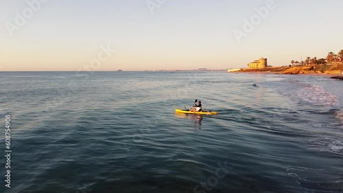 Man kayaking at sunset in Torrevieja, Murcia, Spain photo