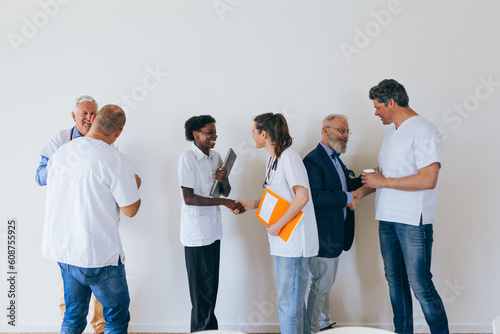 Doctors from a Medical Center Meet in the Meeting Room Exchanging Greetings photo