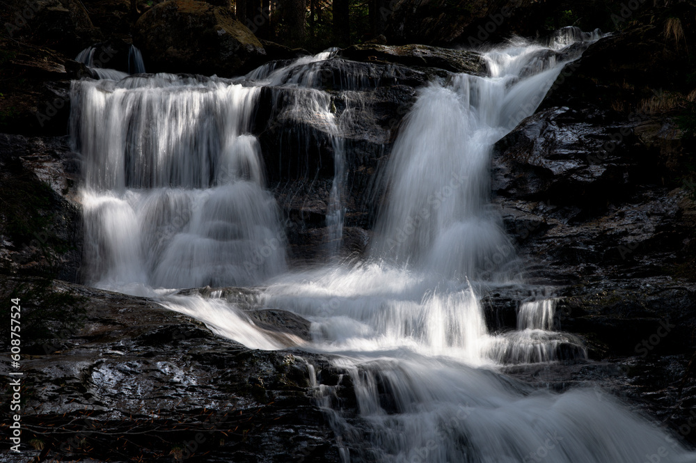 Spring waterfall in the Bavarian Forest with stones