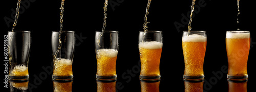 Fotografia Pouring beer into a glass on a black background.