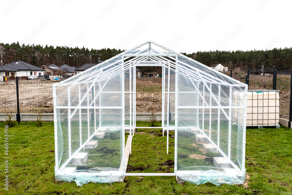 Assembling a home greenhouse from an aluminum frame and thick foil..