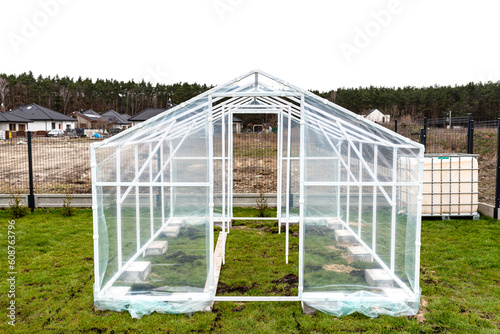 Assembling a home greenhouse from an aluminum frame and thick foil..
