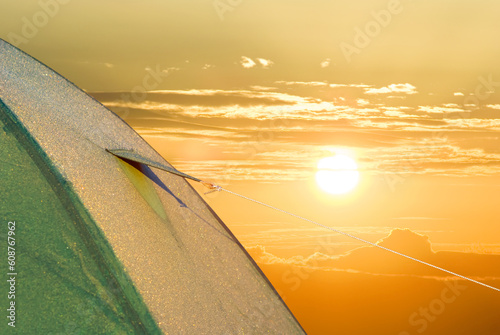 closeup green touristic tent on red dramatic sunset background