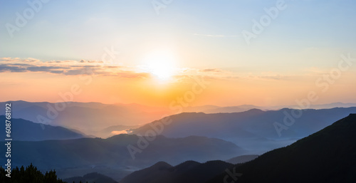 mountain valley in blue mist at the sunrise