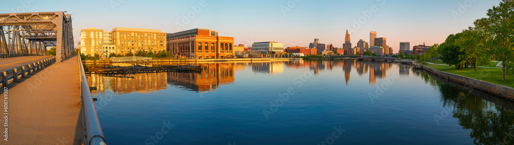 Panoramic metropolitan cityscape at sunrise, skyline and industrial buildings, tranquil water reflections, and the old Point Street Bridge over Providence River in Rhode Island 