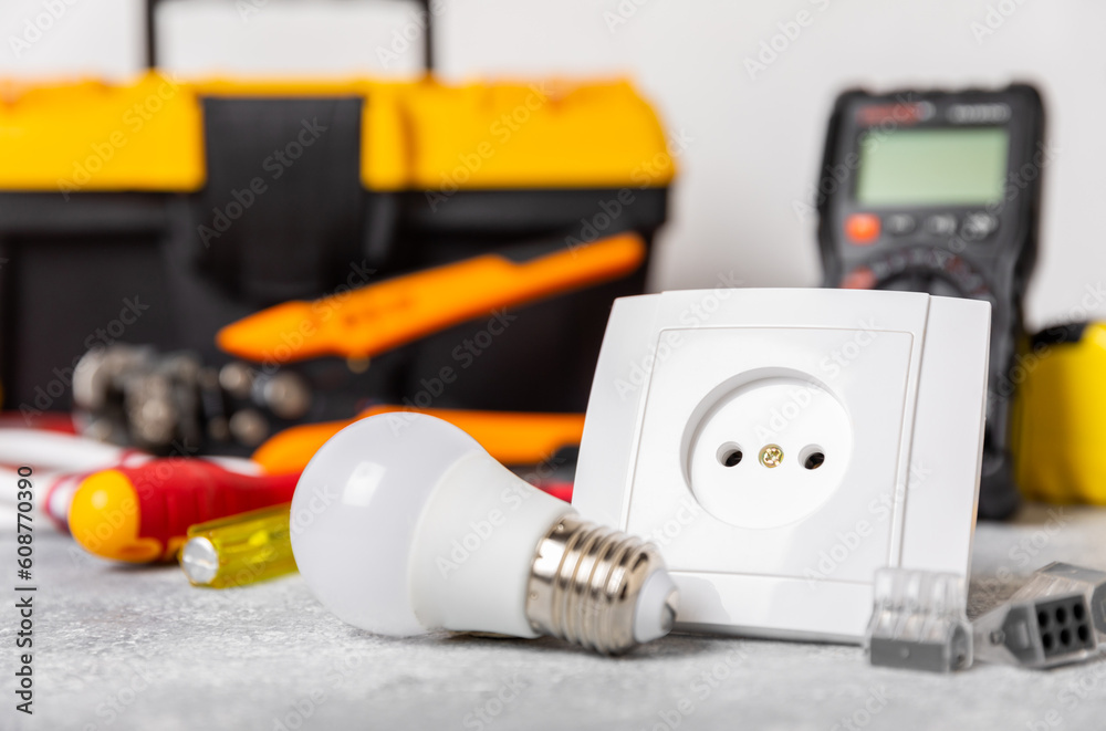 Electrician equipment on marble background with copy space.Top view.Electrician tool set.Multimeter, tester,screwdrivers,cutters,duct tape,lamps,tape measure and wires.Flet lay. Electrician equipment on marble background with copy space.Top view.Electrician tool set.Multimeter, tester,screwdrivers,cutters,duct tape,lamps,tape measure and wires.Flet lay.