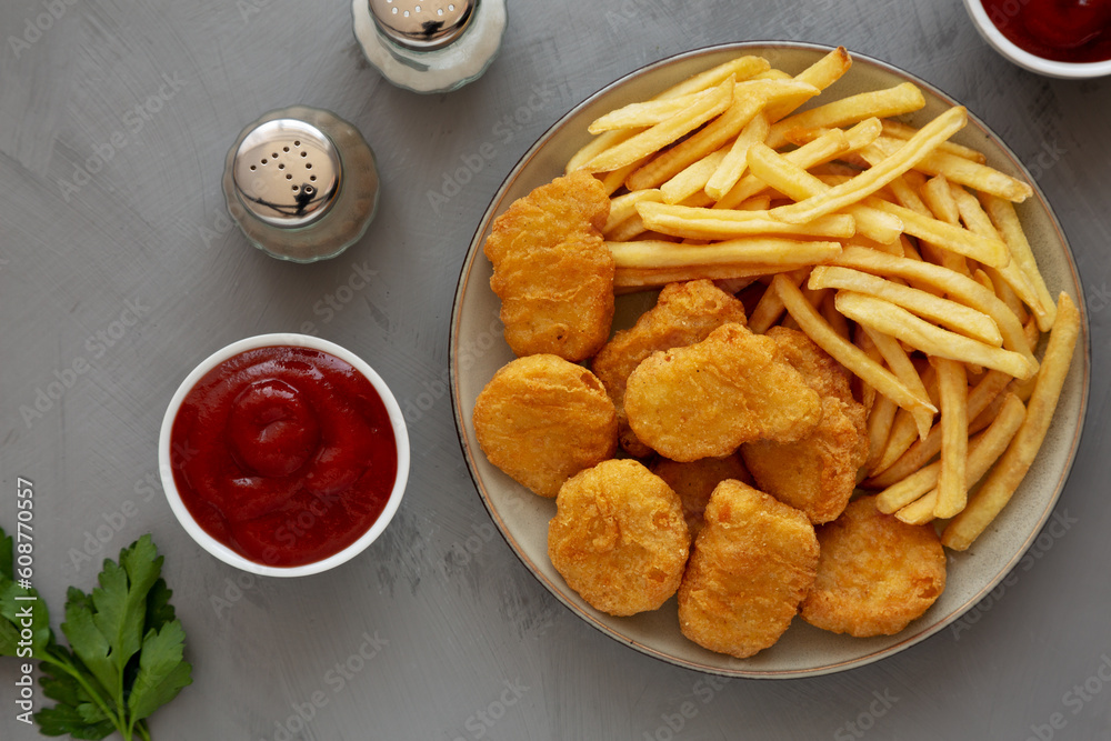 Homemade Chicken Nuggets and French Fries with Ketchup on gray background, top view. Flat lay, overhead, from above.