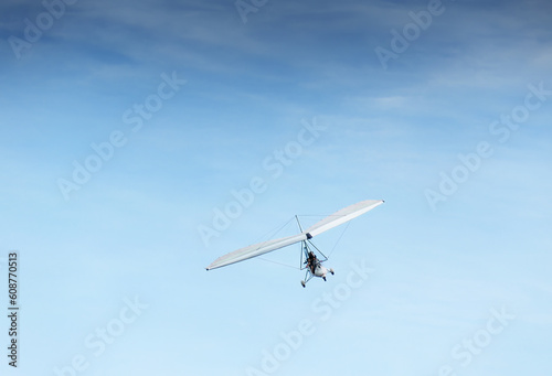 People flying in the powered hang glider