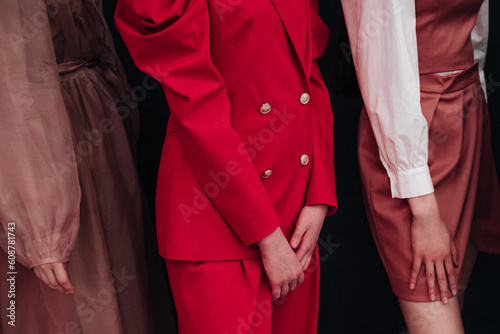 Bright red jacket, brown skirt and lush dress on female bodies. Fashion fancy details. Trendy outfits