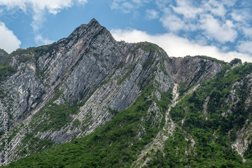 Excursion to Mount Chiampon. View from below starting from Sella Sant'Agnese, Gemona. The summit can be reached from the Foredor saddle along the CAI path n.713.